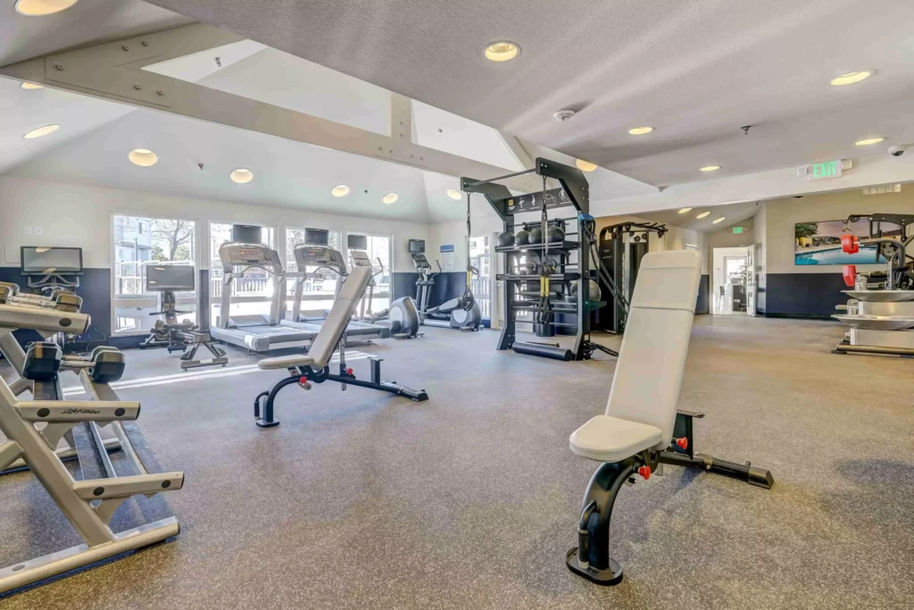Fitness center with cardio equipment at Village Creek apartments in Westminster, CO